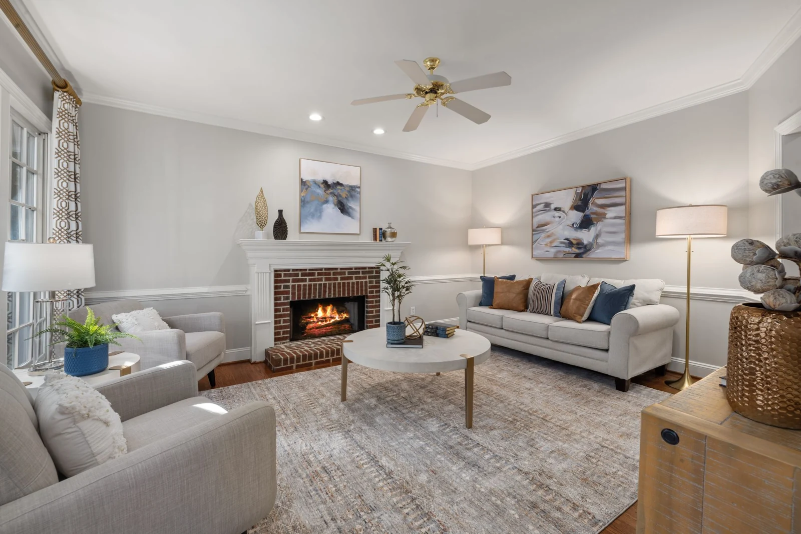 Brick fireplace beside grey seating and a coffee table